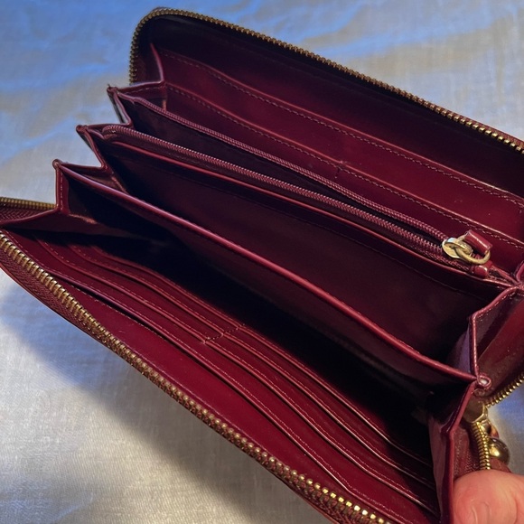 Vintage Monet zip around wallet with tassel on zipper. Maroon in color.